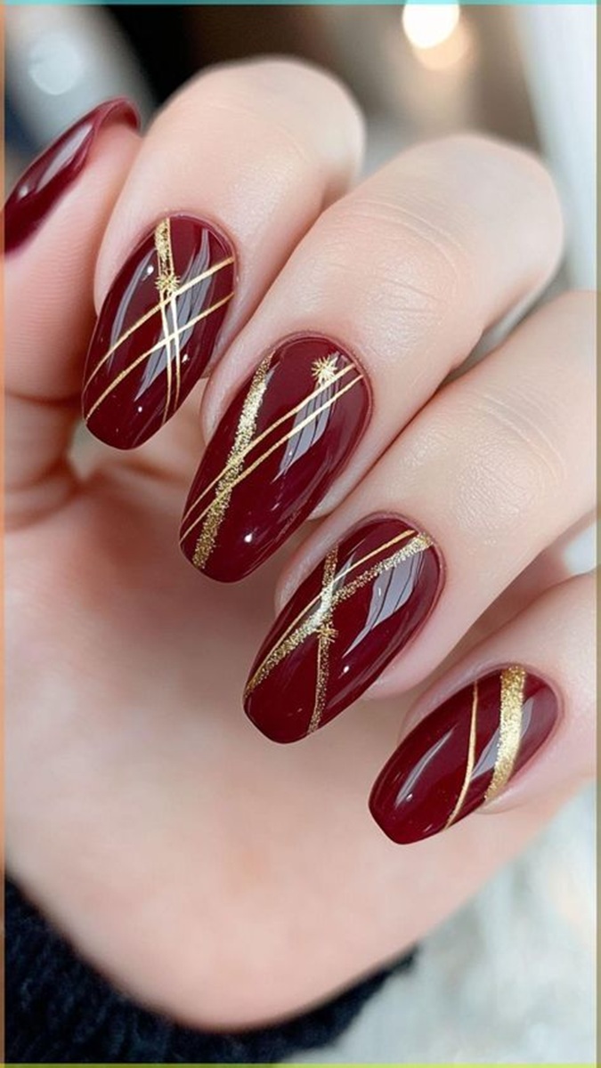 Unhas marsala com detalhes dourados