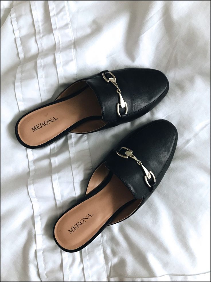 Loafer mule preto com detalhe em fivela prateada, ideal para um estilo sofisticado e confortável.