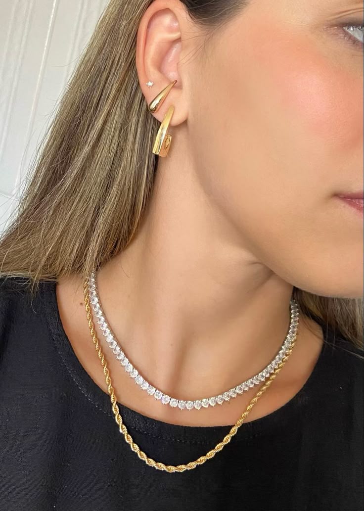 Brincos e colares dourados e prateados combinando perfeitamente, usados por mulher com estilo moderno e sofisticado.