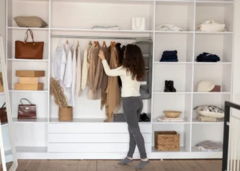 Mulher escolhendo roupas básicas em um guarda-roupa organizado