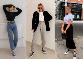 Modelo vestindo uma camiseta branca e calça moletom cinza, combinada com tênis All Star preto de cano alto.