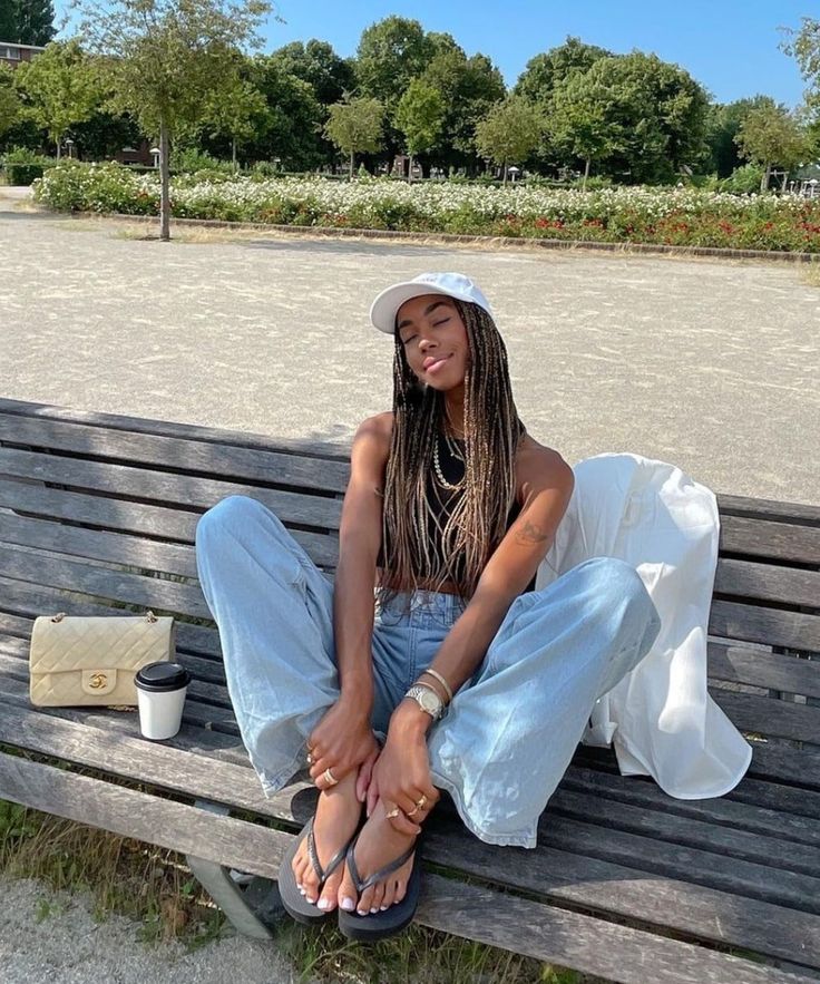 A imagem de uma mulher com um look de verão usando uma regata e saia jeans com chinelos e, ao lado, uma mulher com um look mais elegante de calça amarela, também usando chinelos.