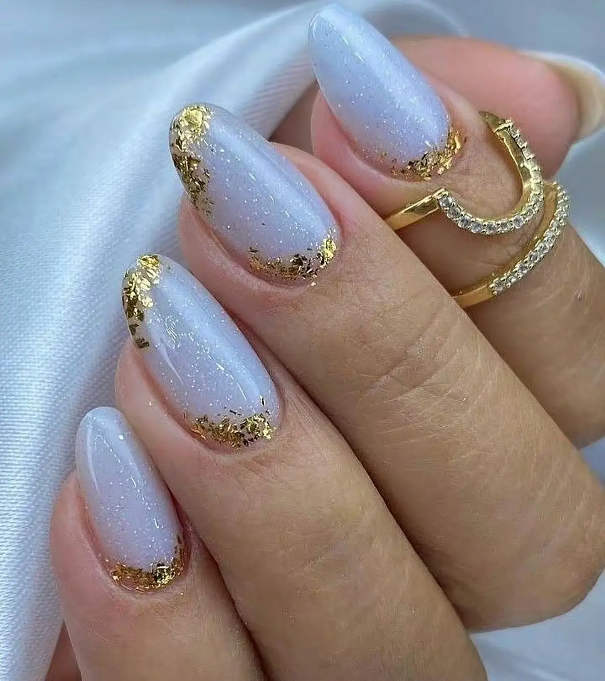 6 inspirações de nail art sofisticadas para o Natal e Ano Novo 5 Unhas com esmalte claro e detalhes de folha de ouro nas pontas.