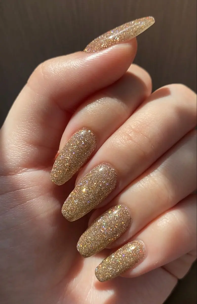 6 inspirações de nail art sofisticadas para o Natal e Ano Novo 7 Unhas longas douradas totalmente cobertas com glitter brilhante.